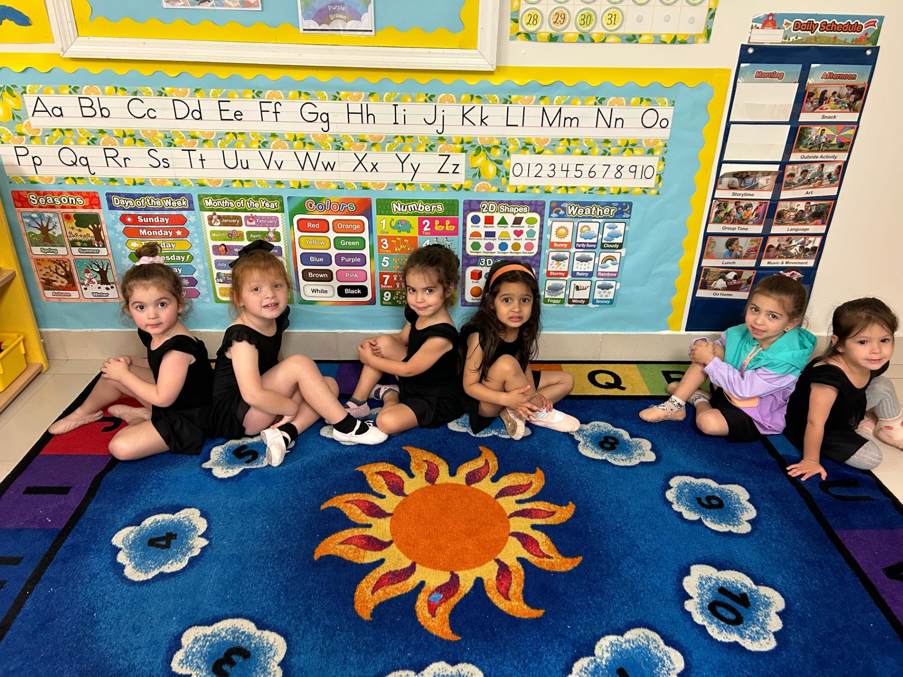 Preschool ballerinas seated in their classroom