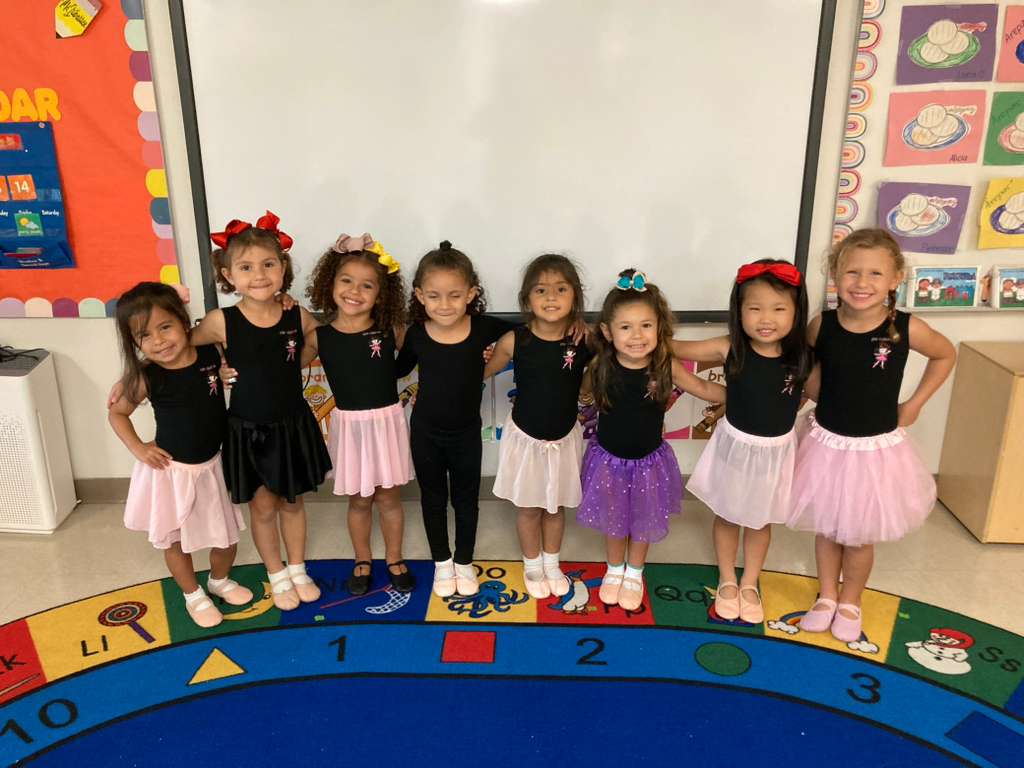 Group of little ballerinas in their tutus posing together