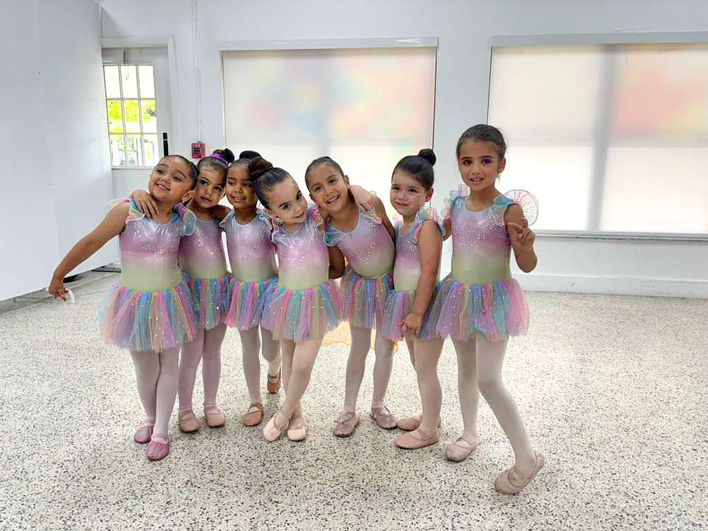 Young ballerina performing on a sparkly stage