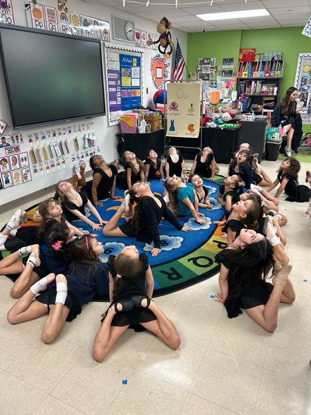 Dancers stretching together in a circle