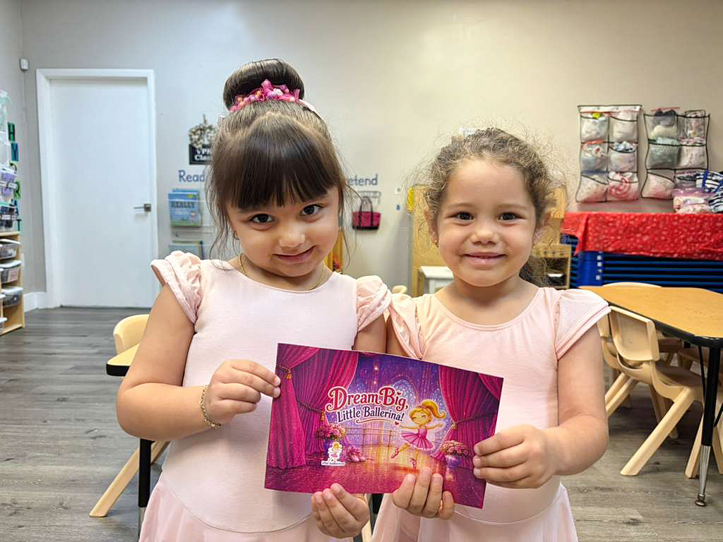 Two little ballerinas holding the Dream Big, Little Ballerina! storybook